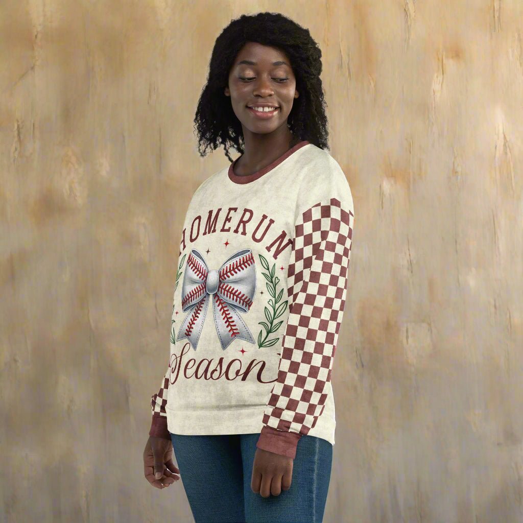 Person wearing a sweater with 'Homerun Season' text and design against a wooden background
