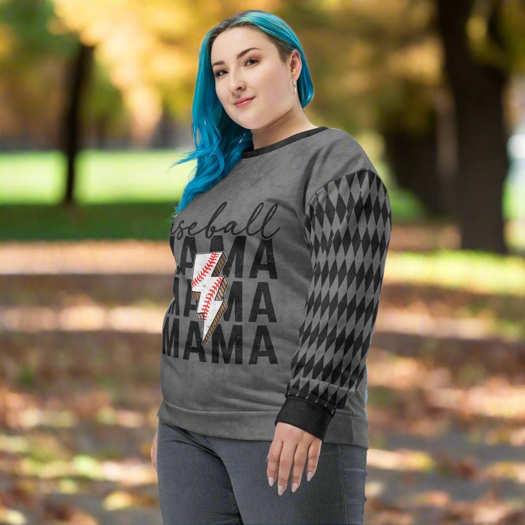Woman wearing a gray sweatshirt with 'Baseball Mama' text and checkered sleeves outdoors