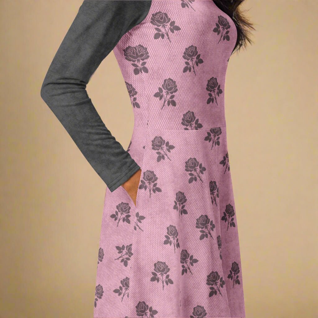Pink dress with charcoal rose pattern worn by a person on a beige background