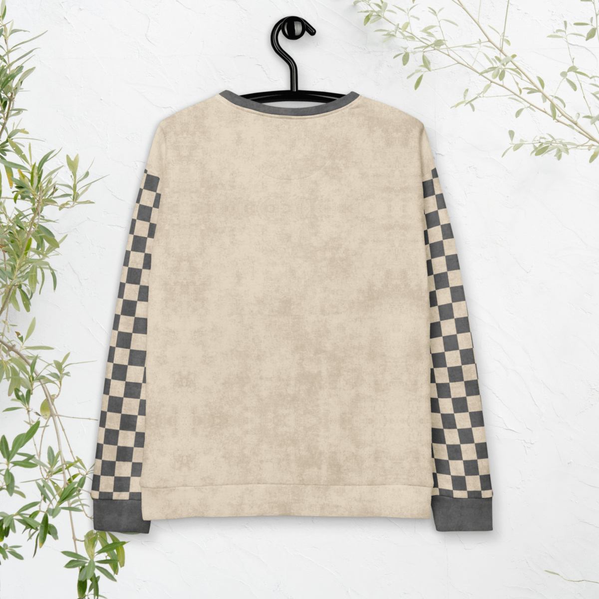 Beige sweatshirt with checkered sleeves on a hanger against a white background
