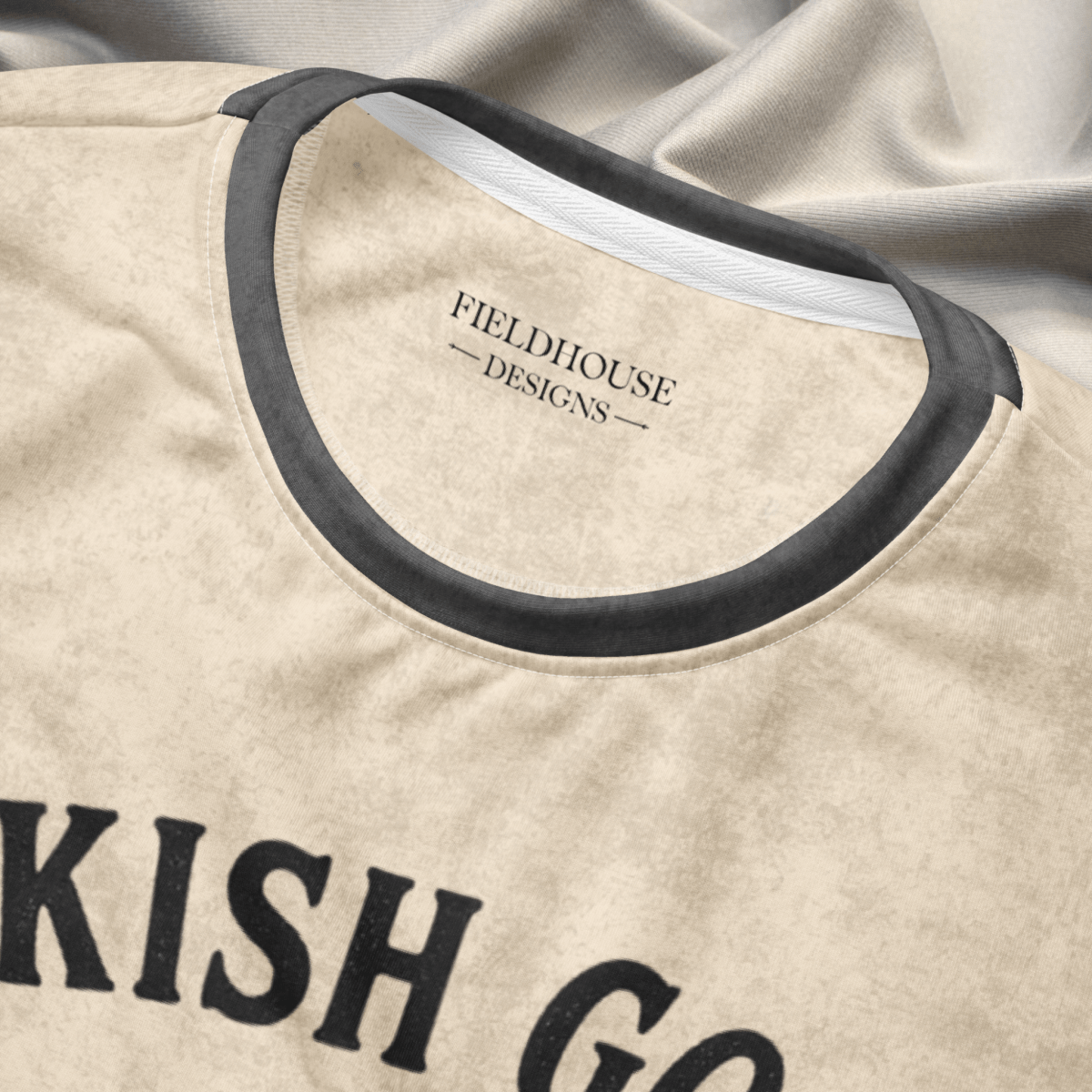 Beige and gray crewneck sweatshirt neckline and 'Fieldhouse Designs' branding.