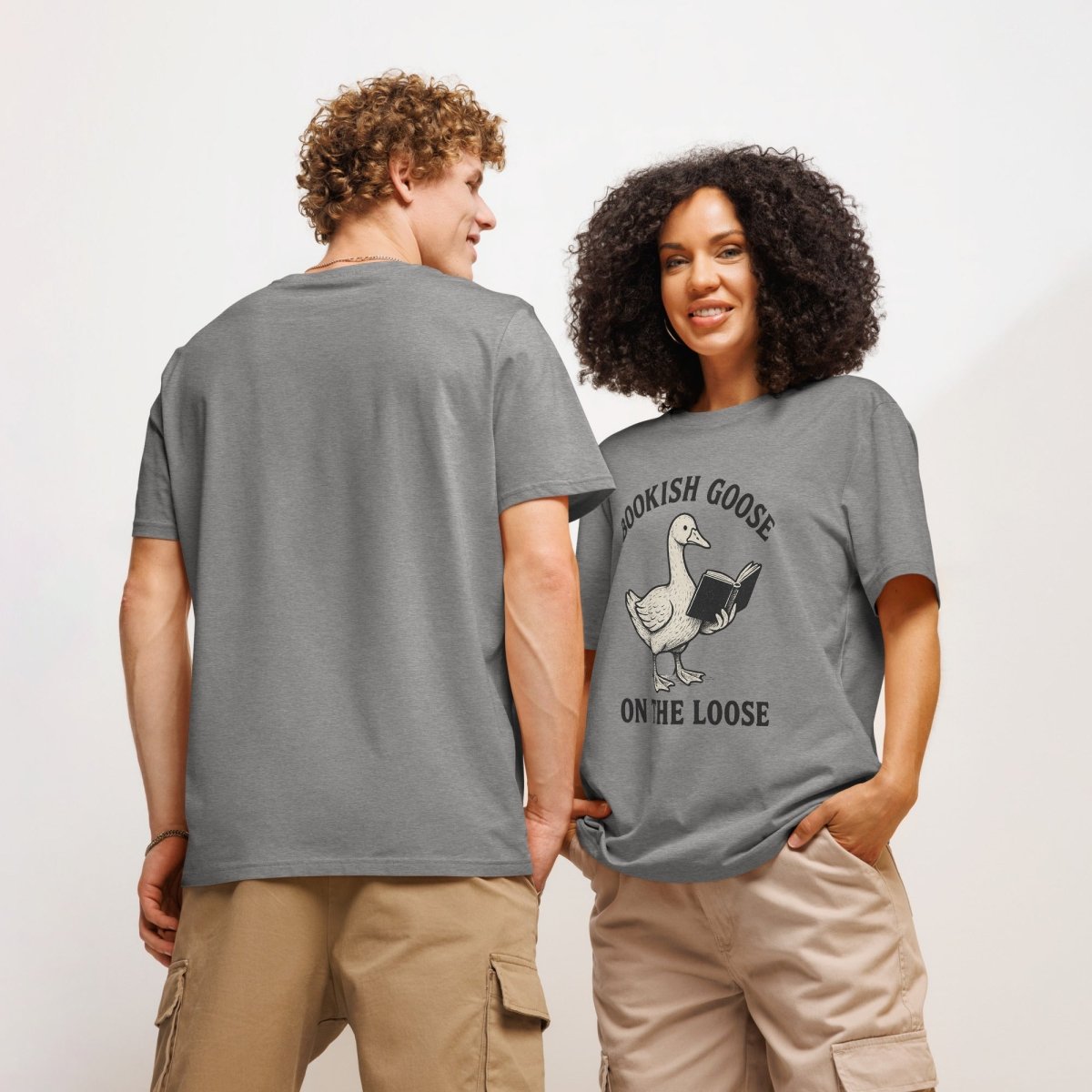 Two people wearing gray t-shirts with a goose design and text "Bookish Goose on the Loose" on a plain background