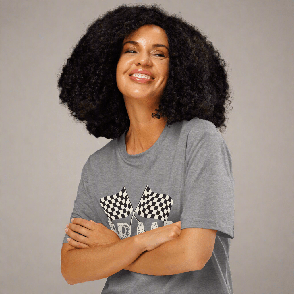 Woman wearing a gray t-shirt with checkered flag design on a neutral background