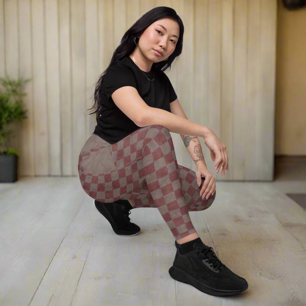 Person wearing checkered leggings and black shoes on a porch
