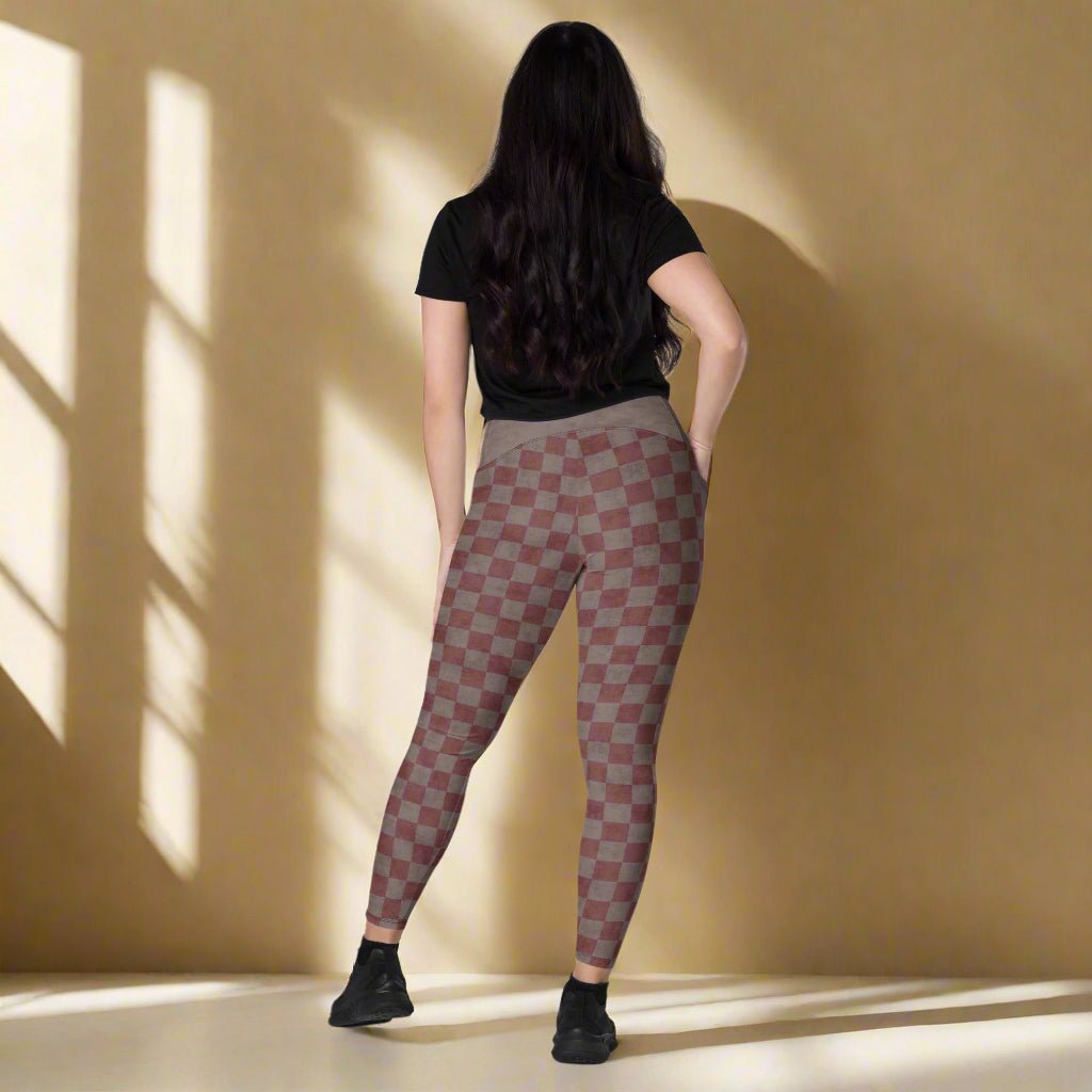 Person wearing checkered leggings on a neutral background