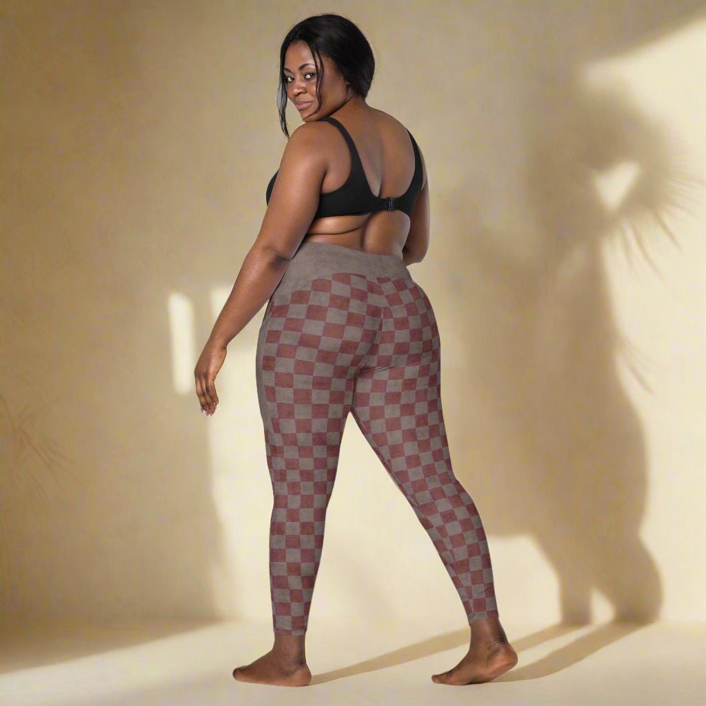 Woman wearing checkered leggings on a neutral background