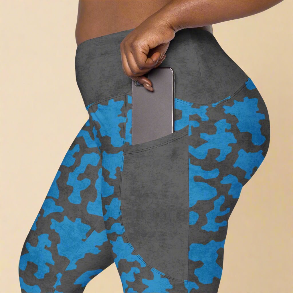 Blue and gray camouflage leggings with a pocket on a beige background
