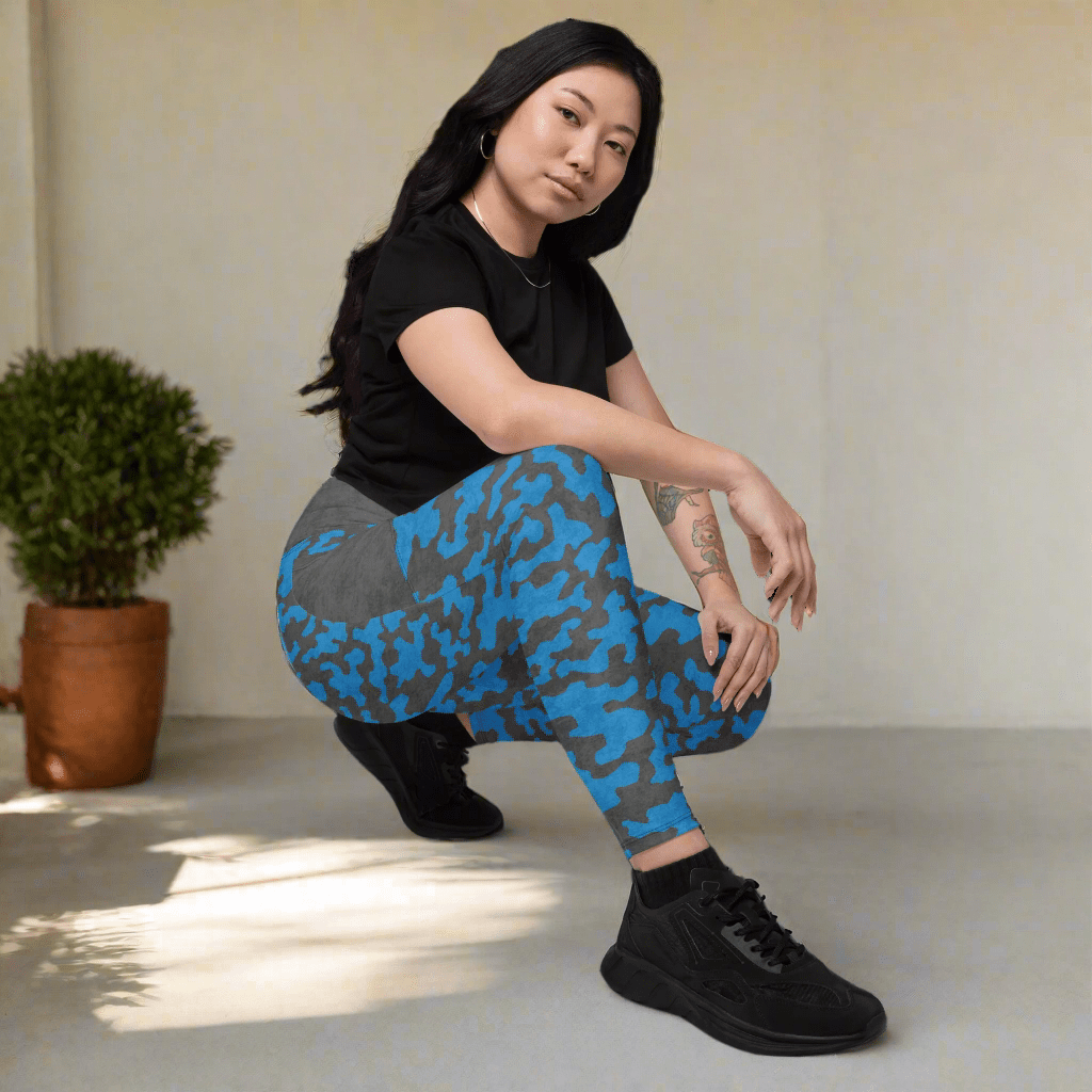 Person wearing blue and gray patterned leggings on a neutral background