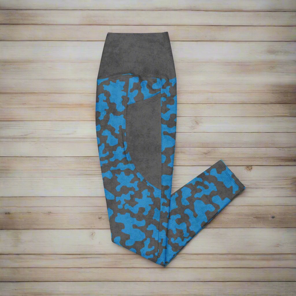 Gray leggings with blue camouflage pattern on a wood background