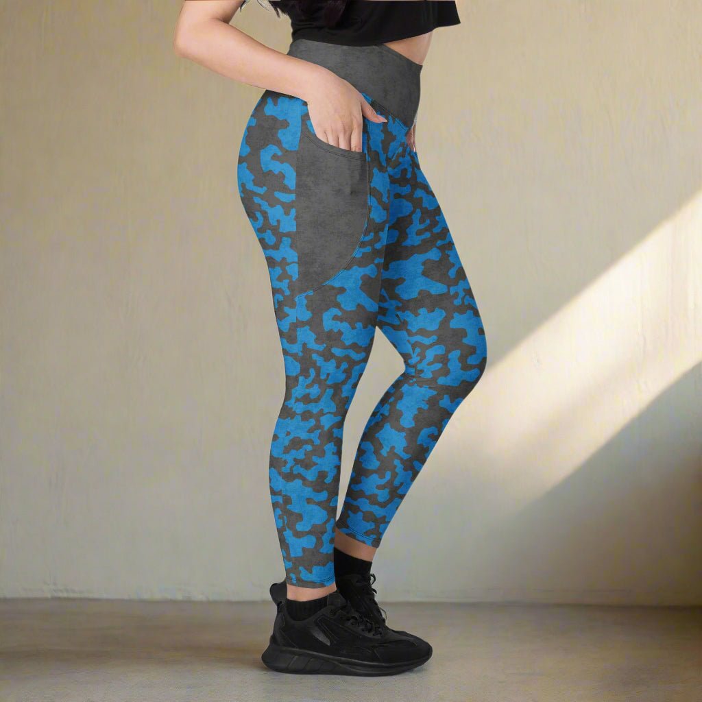 Person wearing blue and gray camouflage leggings with a plain background