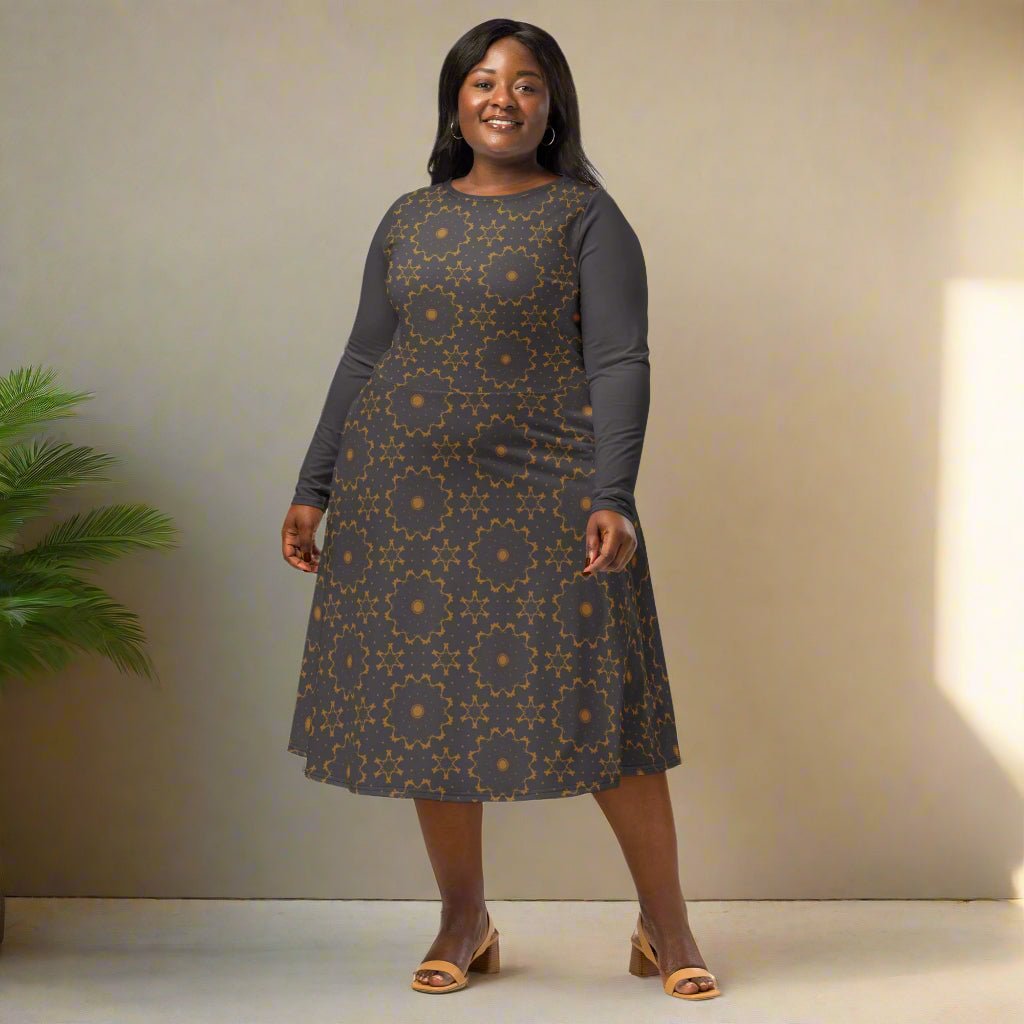 Woman wearing a patterned dress standing against a neutral background