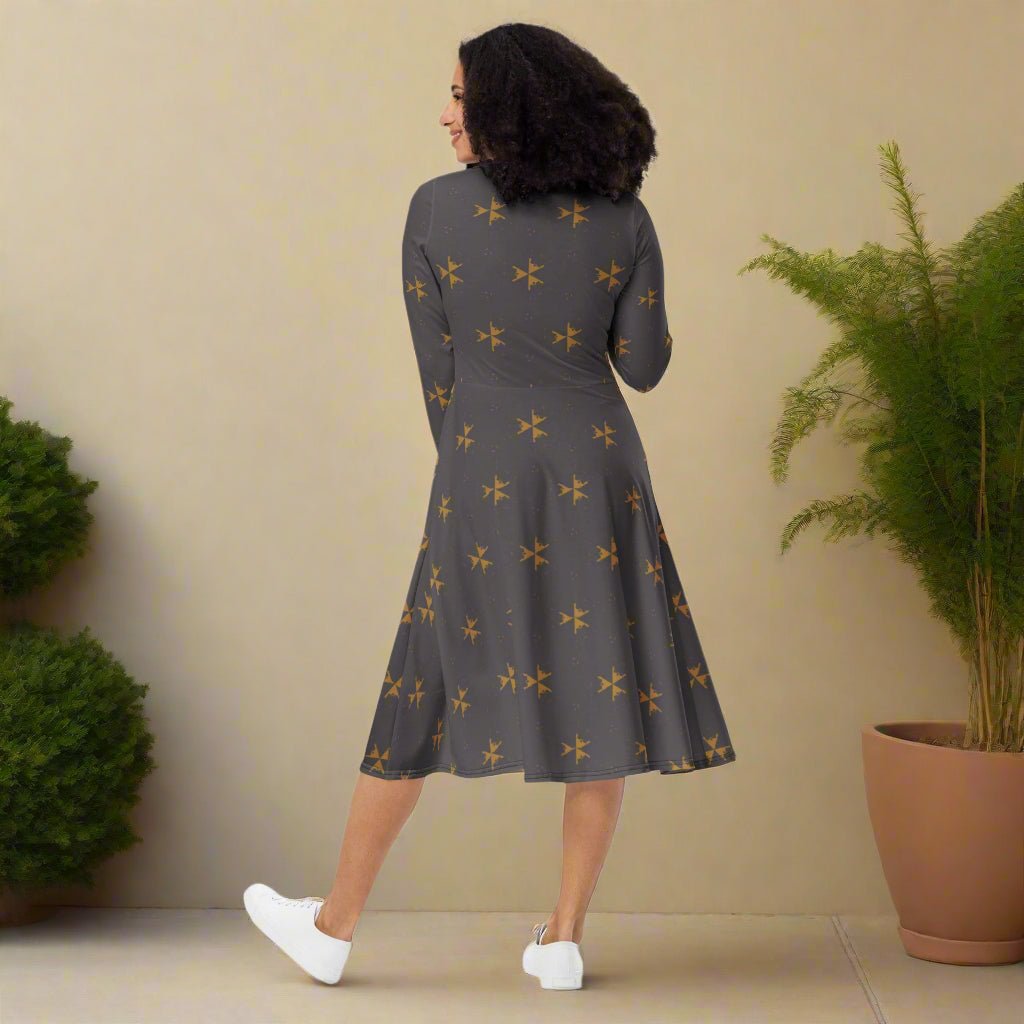 Woman wearing a gray dress with star pattern on a neutral background