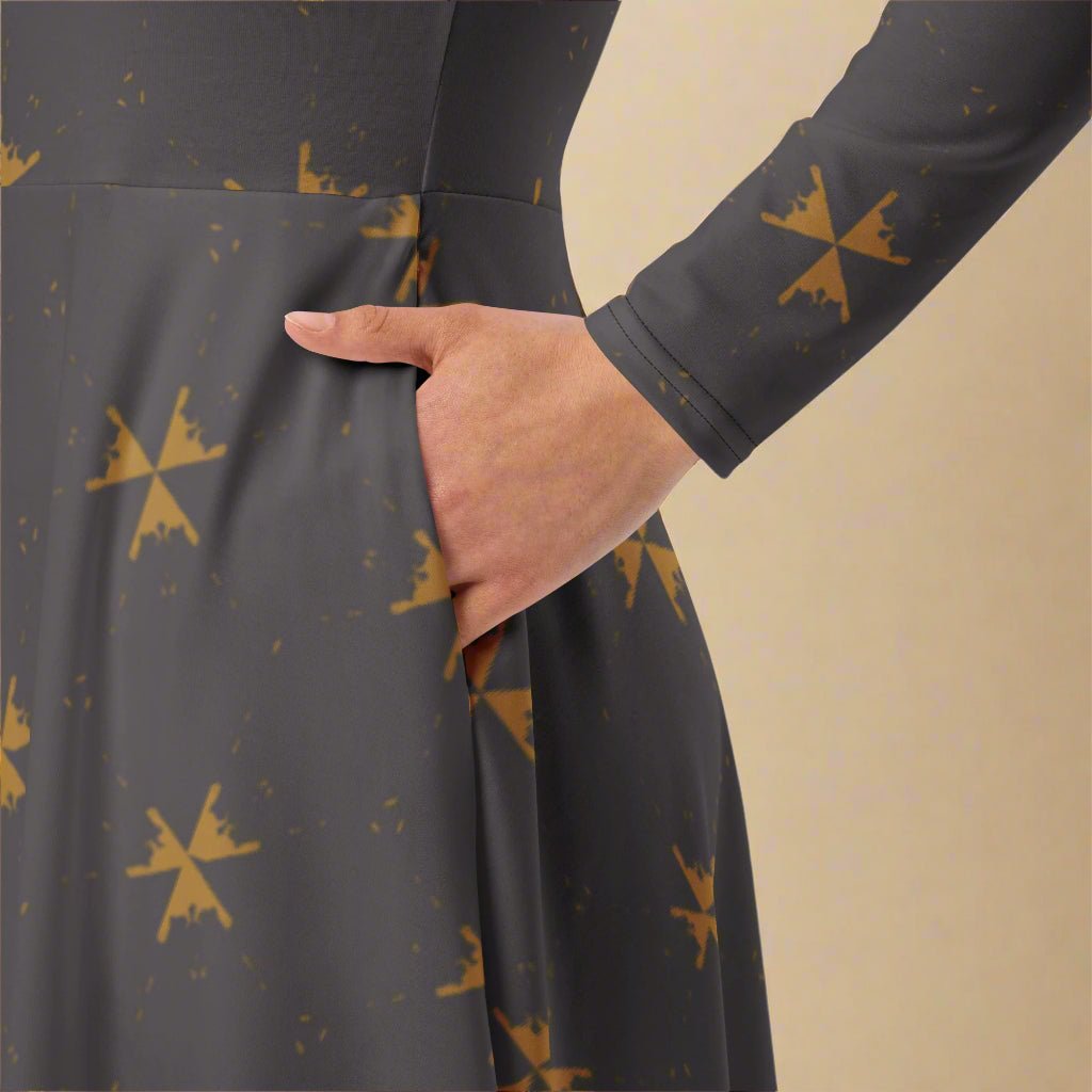 Dark gray dress with gold abstract patterns and a hand in the pocket