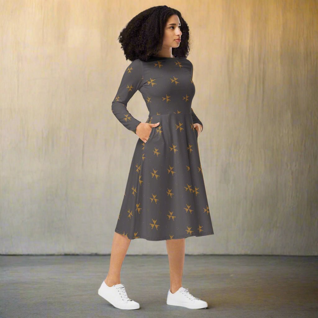 Woman wearing a dark gray dress with a subtle pattern, standing against a plain background