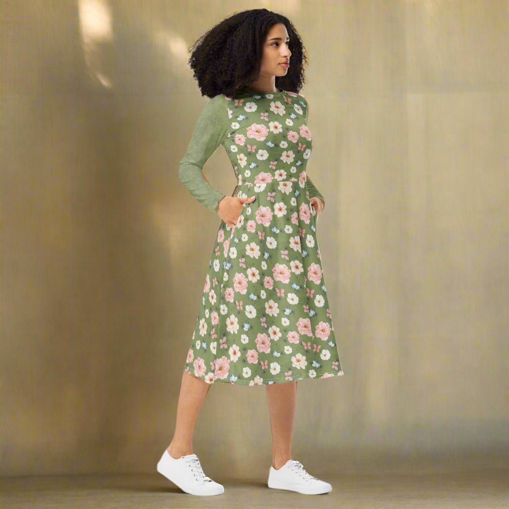 Woman wearing a green floral dress on a neutral background