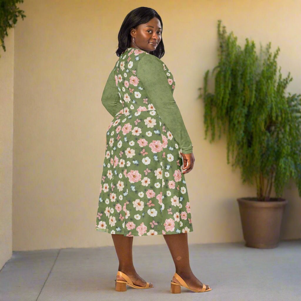 Woman wearing a green floral dress on a neutral background