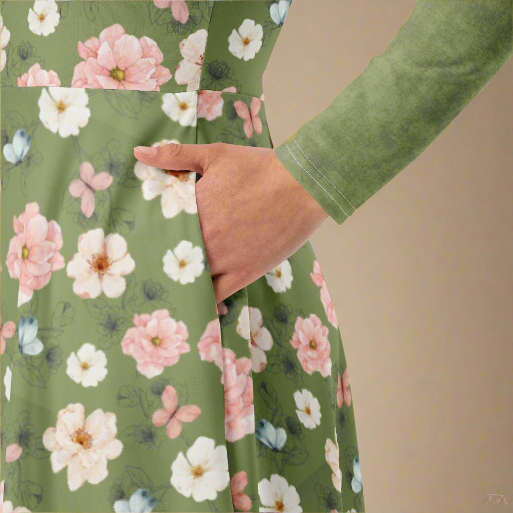 Green dress with floral pattern worn by a person, against a beige background