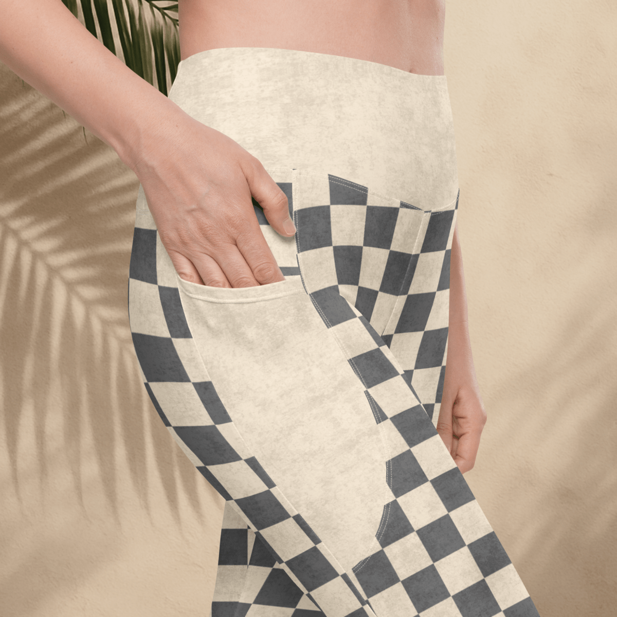 Person wearing checkered leggings with a neutral background
