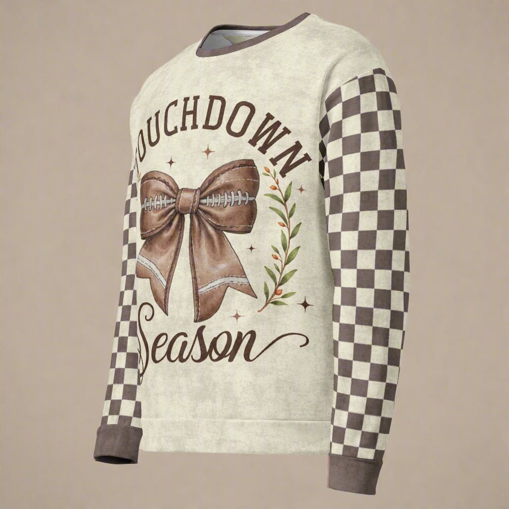 Sweater with 'Touchdown Season' design featuring a bow and football on a beige background