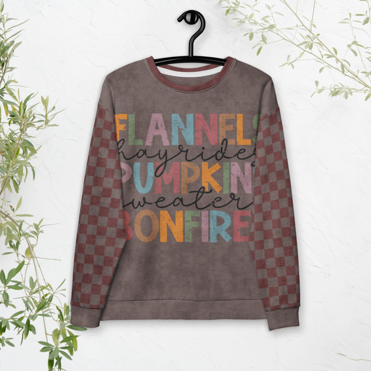 Espresso and burgundy Sweatshirt with colorful text and checkered pattern on a hanger against a white background