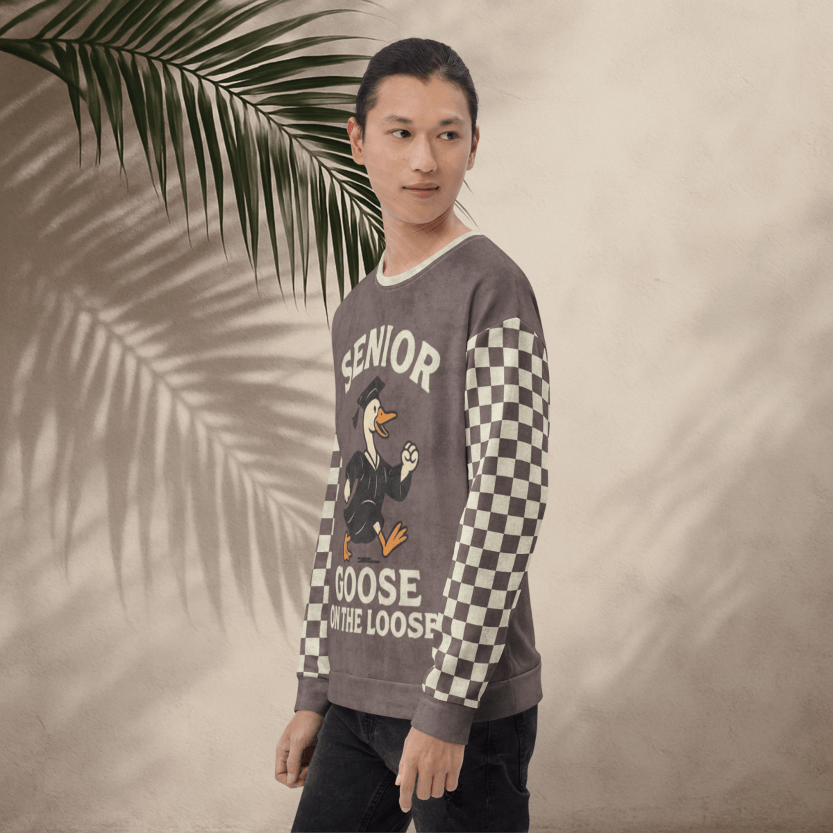model wearing a sweater with 'Senior Goose on the Loose' design against a beige background