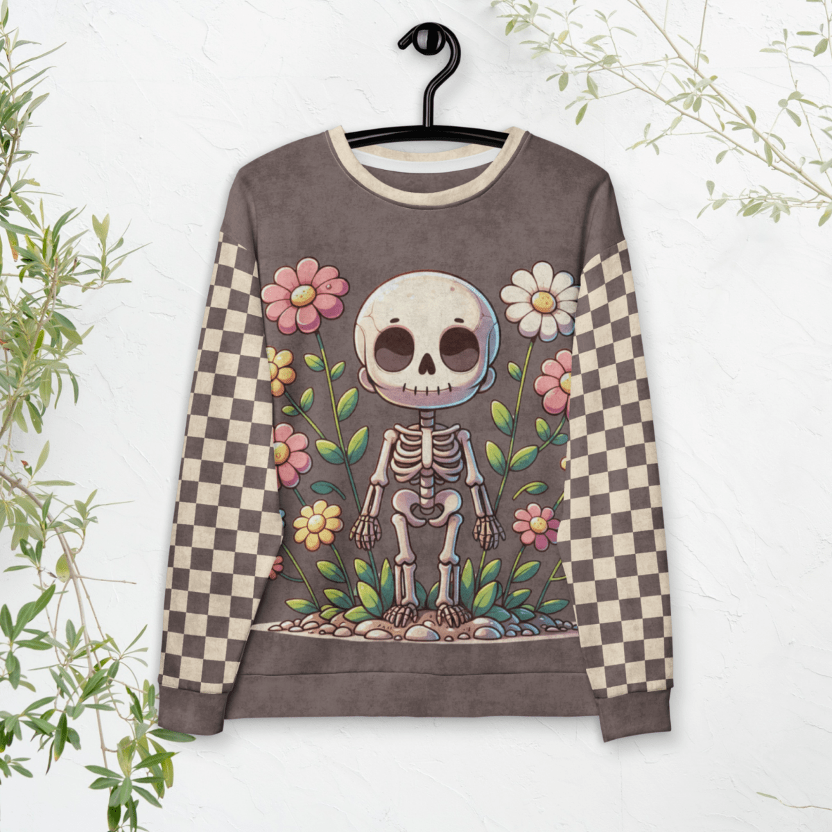 Sweatshirt with a skeleton and floral design on a hanger against a white background