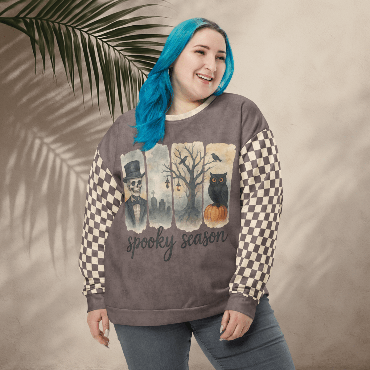 Person wearing a 'spooky season' sweatshirt with checkered sleeves against a beige background