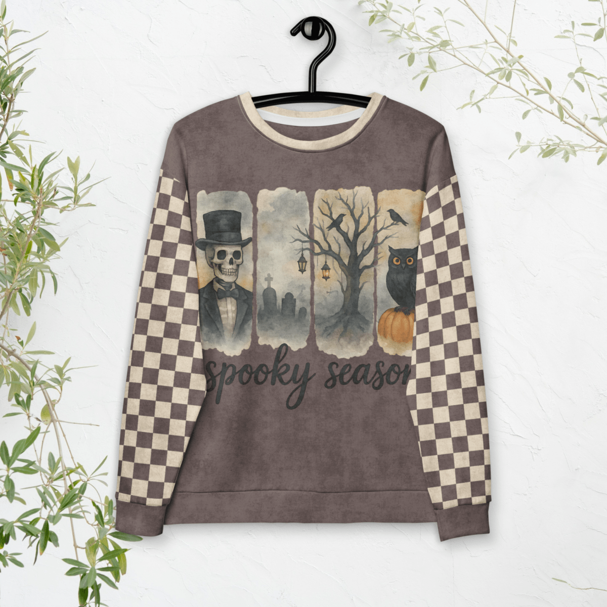 Sweatshirt with Halloween-themed design on a hanger against a white background