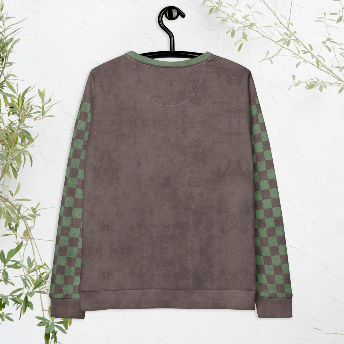Espresso and sage green sweatshirt with checkered sleeves on a hanger against a white background