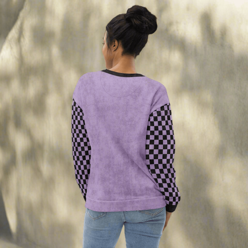 Person wearing a purple sweatshirt with checkered sleeves on a neutral background