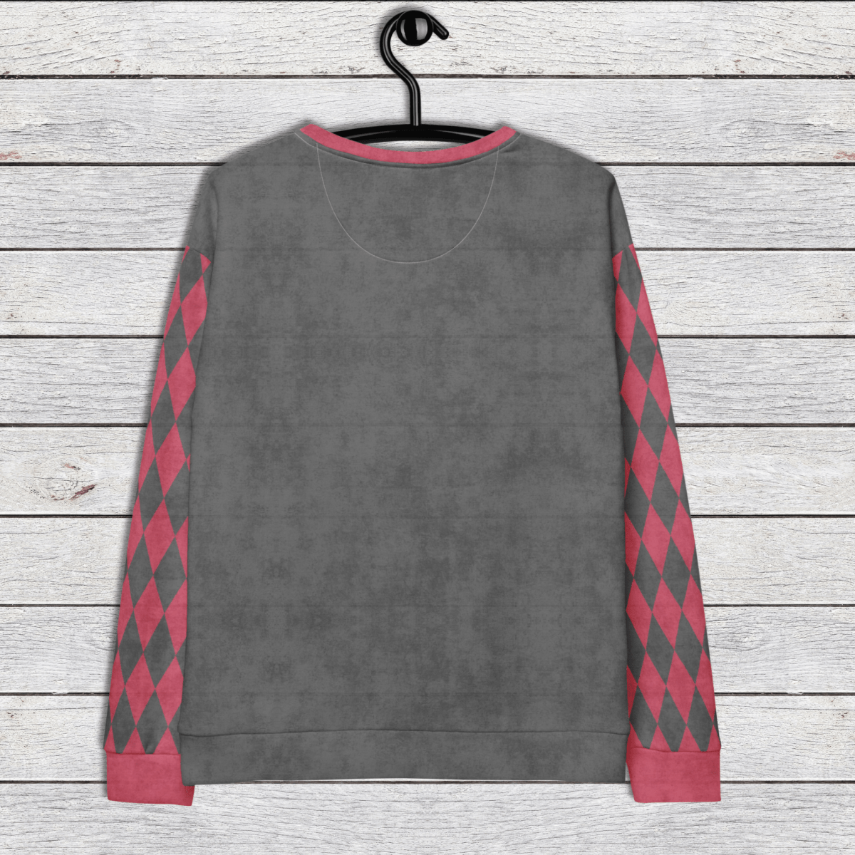 Gray sweatshirt with pink and gray argyle pattern on sleeves, hanging on a wooden surface.