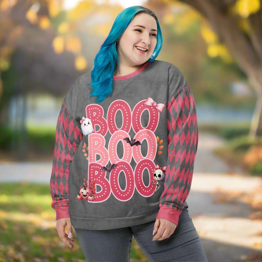 Person wearing a sweater with 'BOO BOO BOO' text and Halloween graphics outdoors.