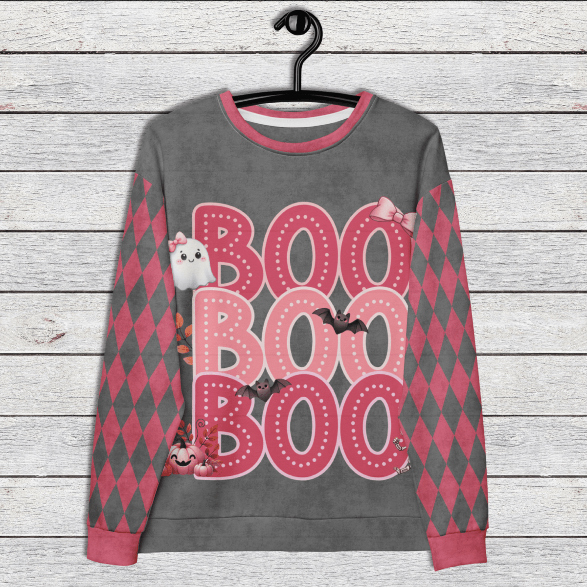 Gray sweatshirt with pink 'BOO BOO BOO' text and Halloween graphics on a wooden surface.
