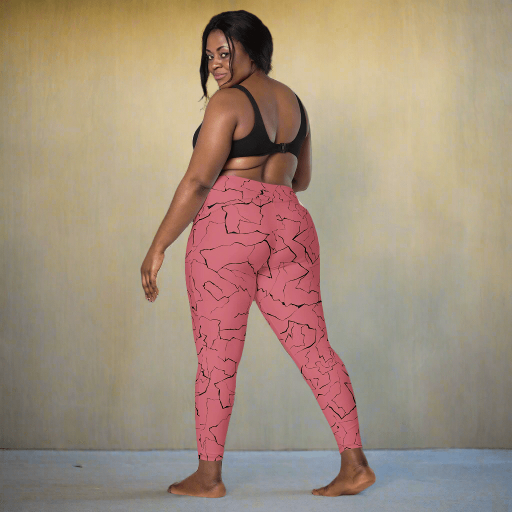 Woman wearing pink leggings with black pattern on a neutral background