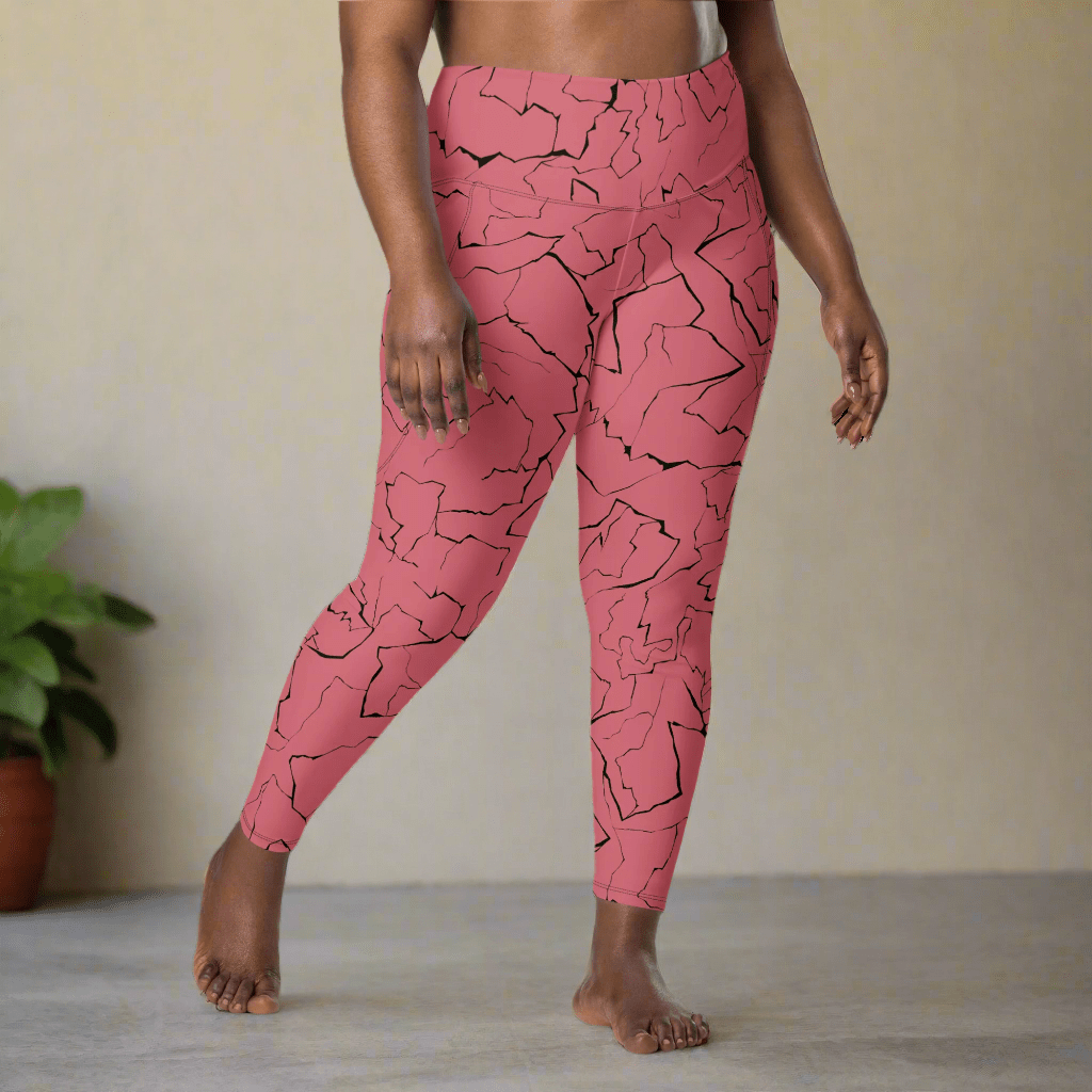 Person wearing pink leggings with black abstract pattern in a minimal indoor setting