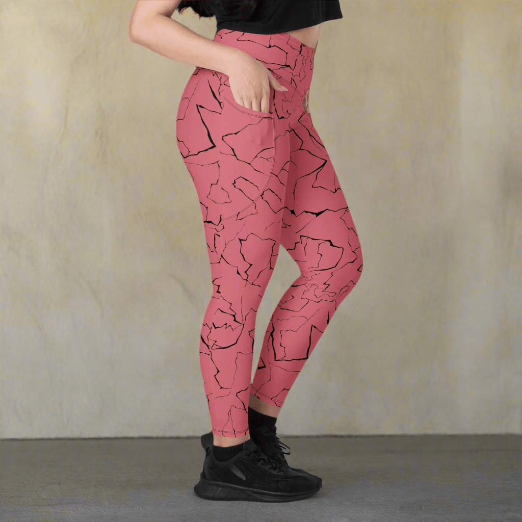 Pink leggings with black abstract pattern worn by a person on a neutral background