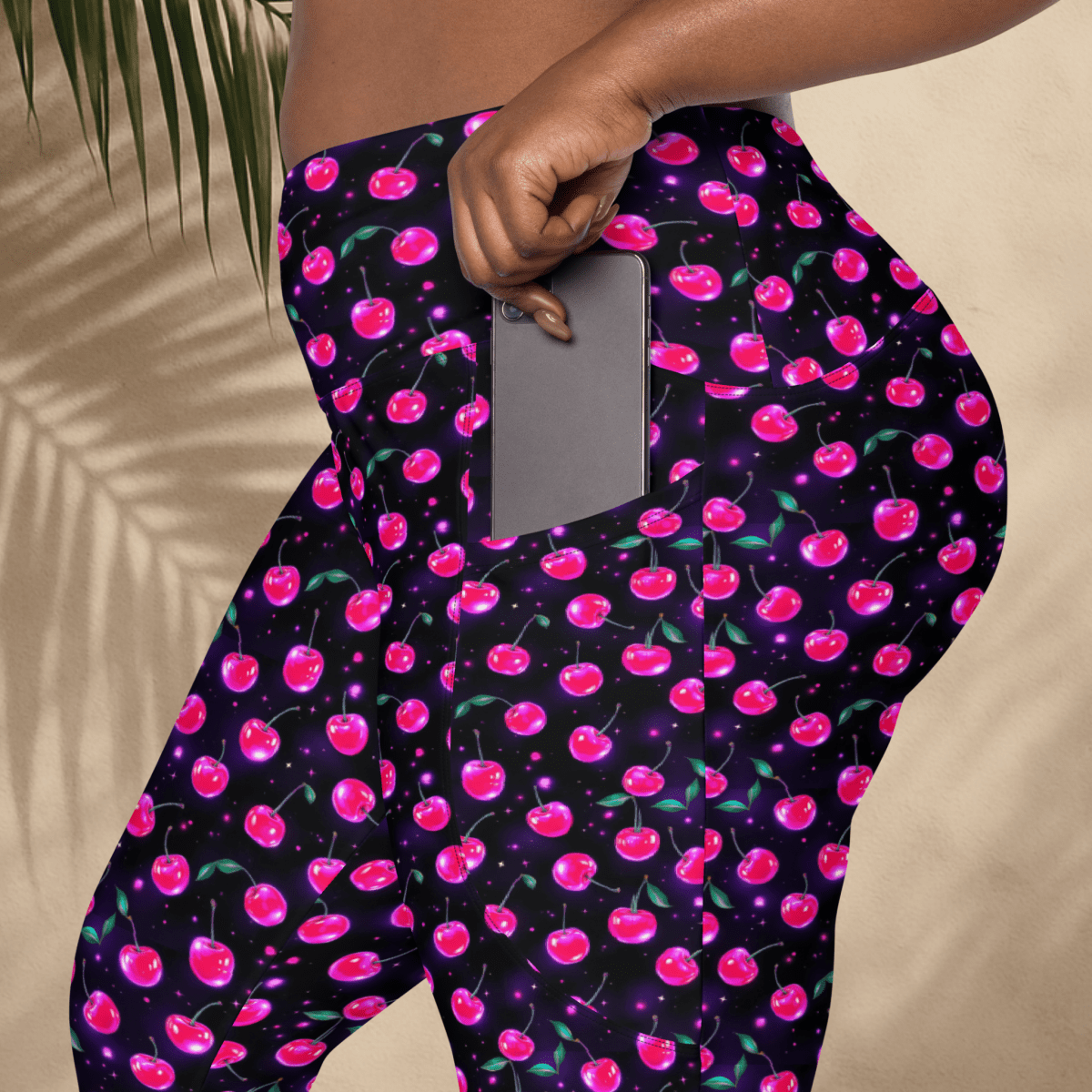Leggings with pink cherry pattern on a dark background