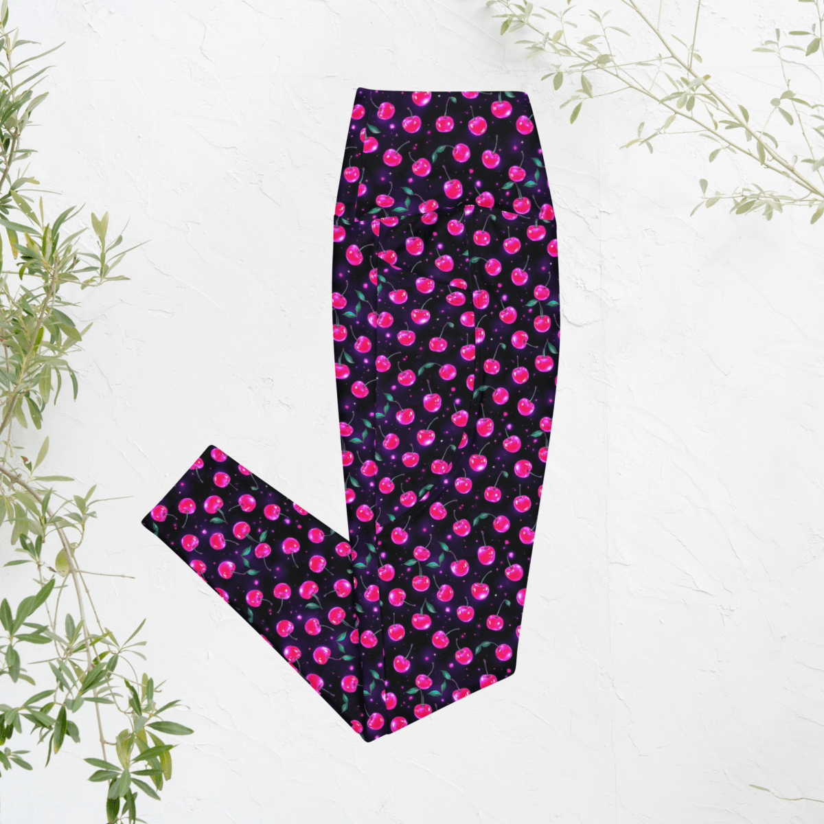 Leggings with pink cherry print on black on a white background