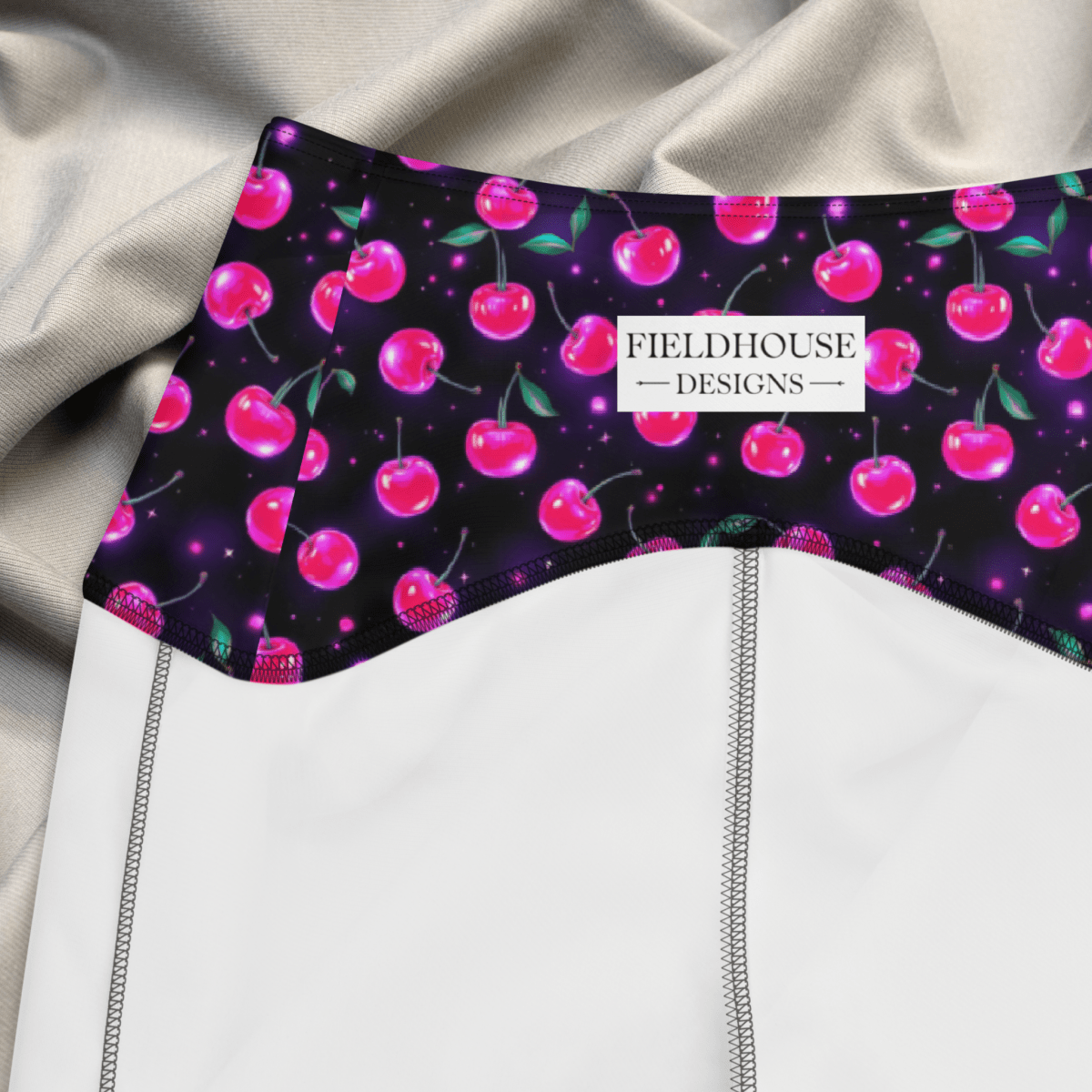 Product with cherry pattern and 'Fieldhouse Designs' label on a textured fabric background