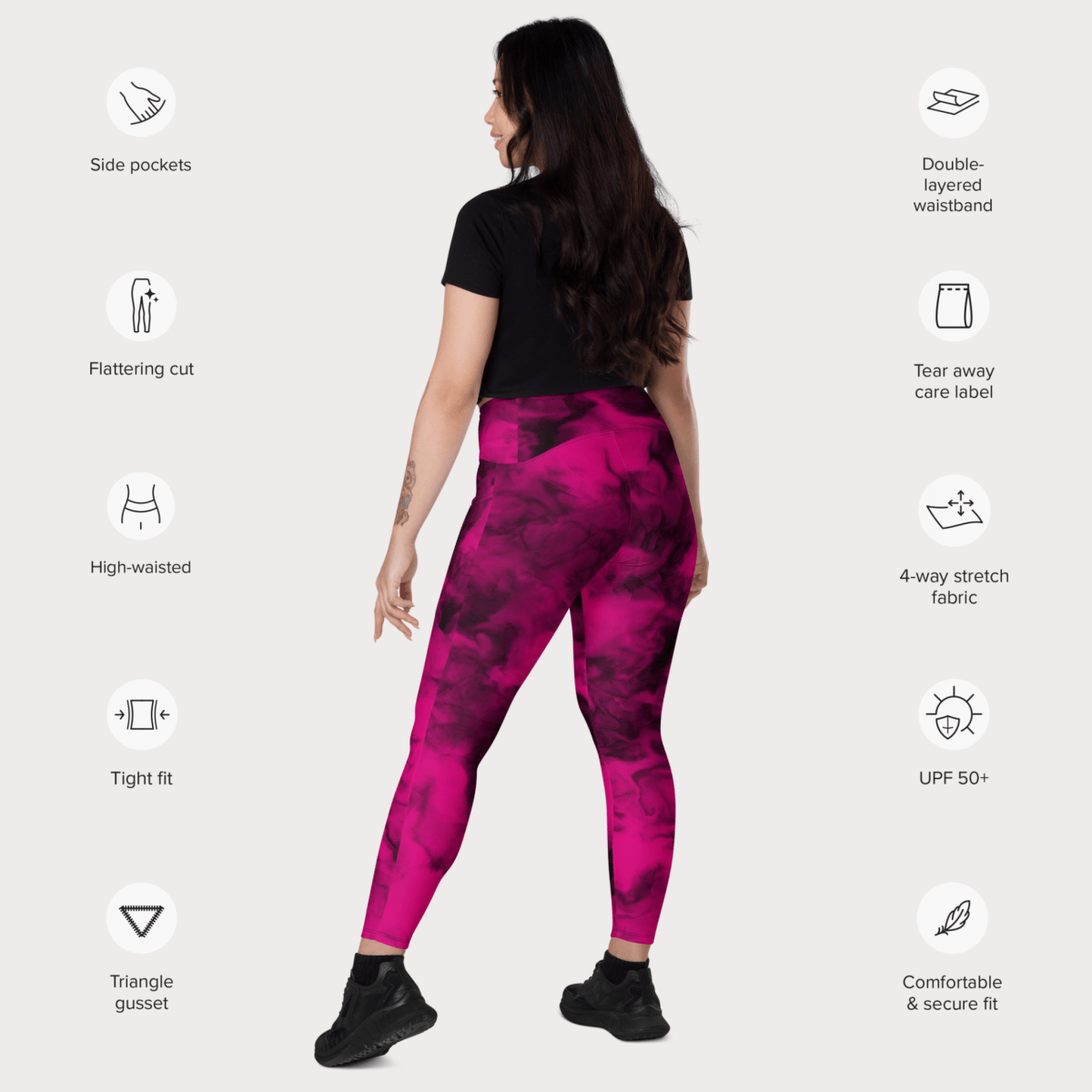 Woman wearing pink leggings with feature icons on a white background