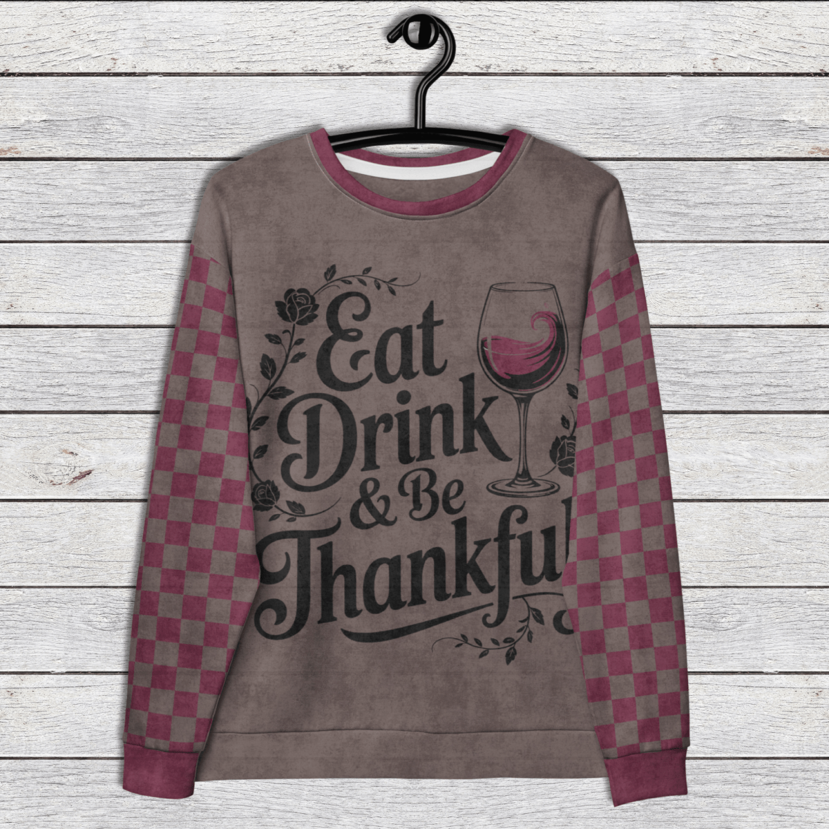 Checkered sleeve crewneck Sweatshirt with 'Eat Drink & Be Thankful' text and wine glass graphic on a wooden background
