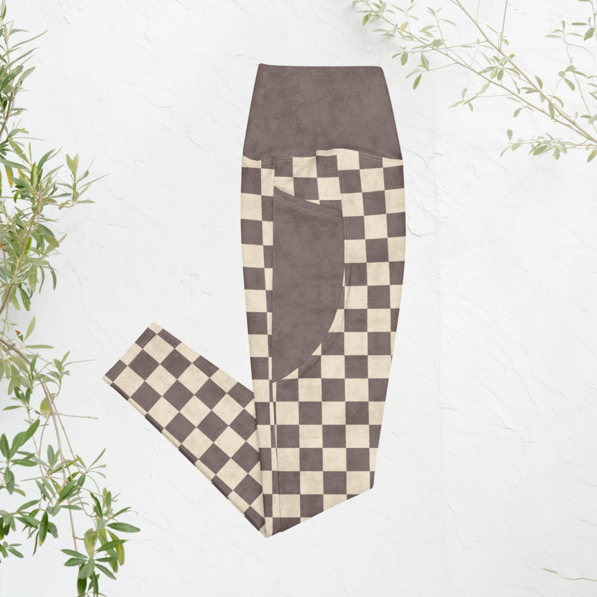 Checkered leggings with espresso and cream pattern on a light background