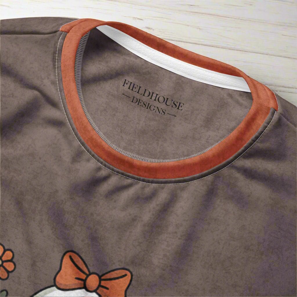 Close-up of a brown shirt with a visible brand logo and design elements.