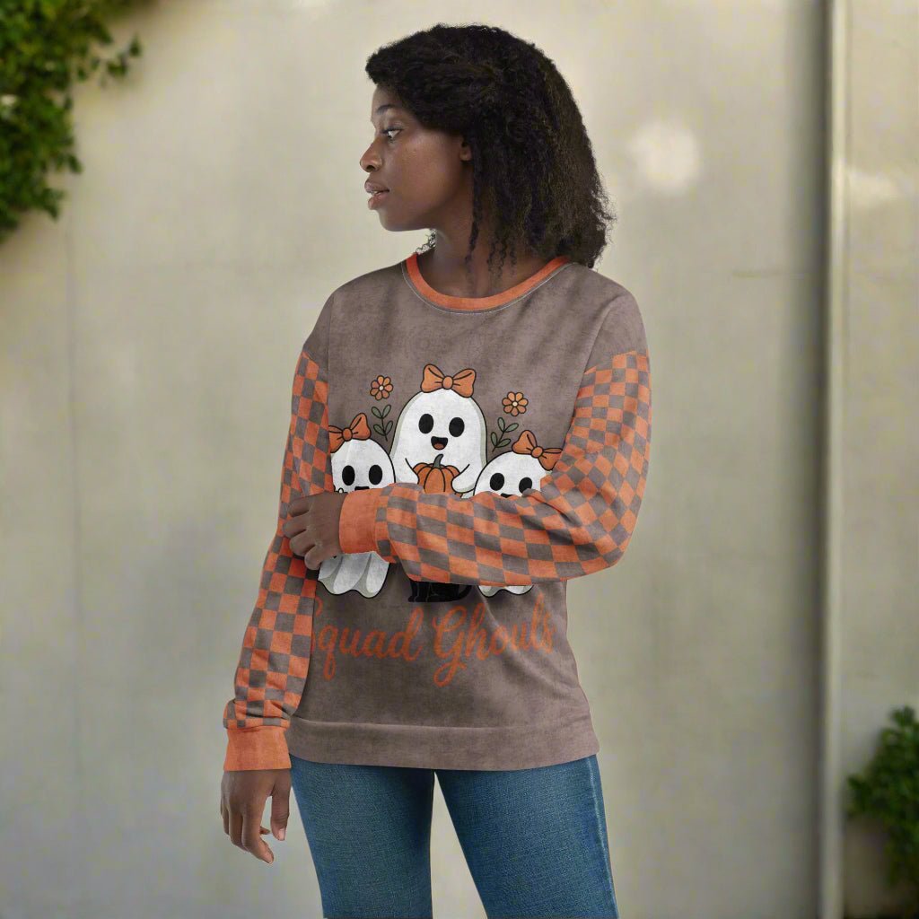 Person wearing a sweater with ghost designs and 'Squad Ghouls' text on a neutral background
