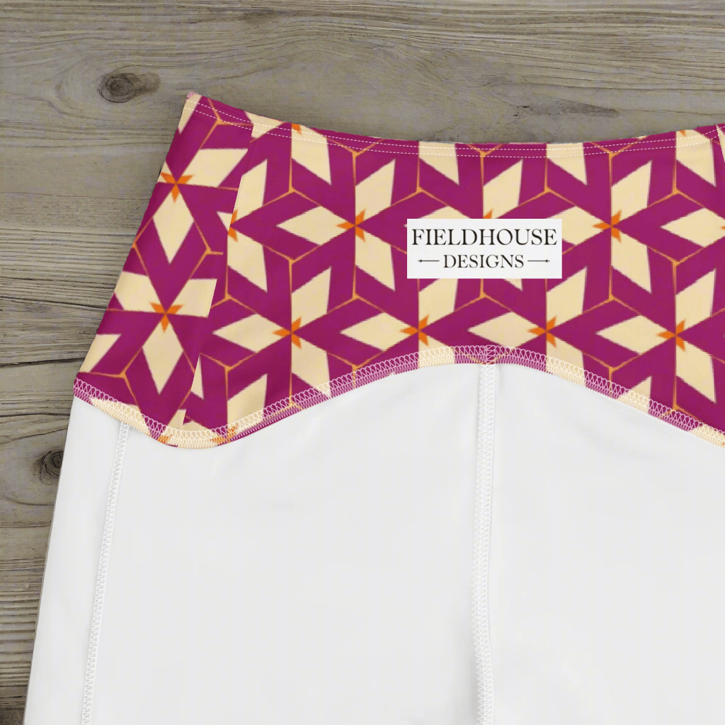 White pants with a geometric patterned waistband on a wooden surface, featuring 'Fieldhouse Designs' branding.