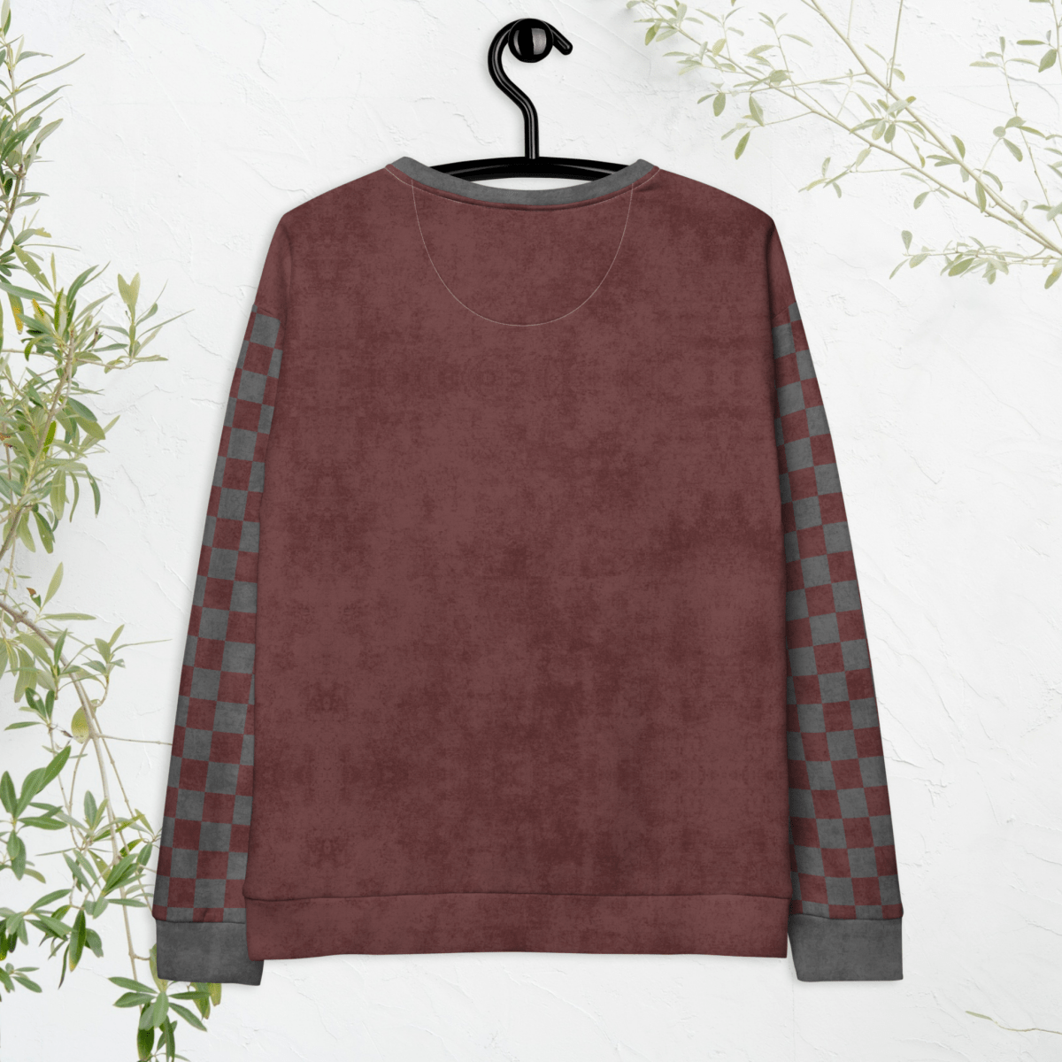 back side of burgundy sweatshirt with checkered sleeves on a hanger against a white background