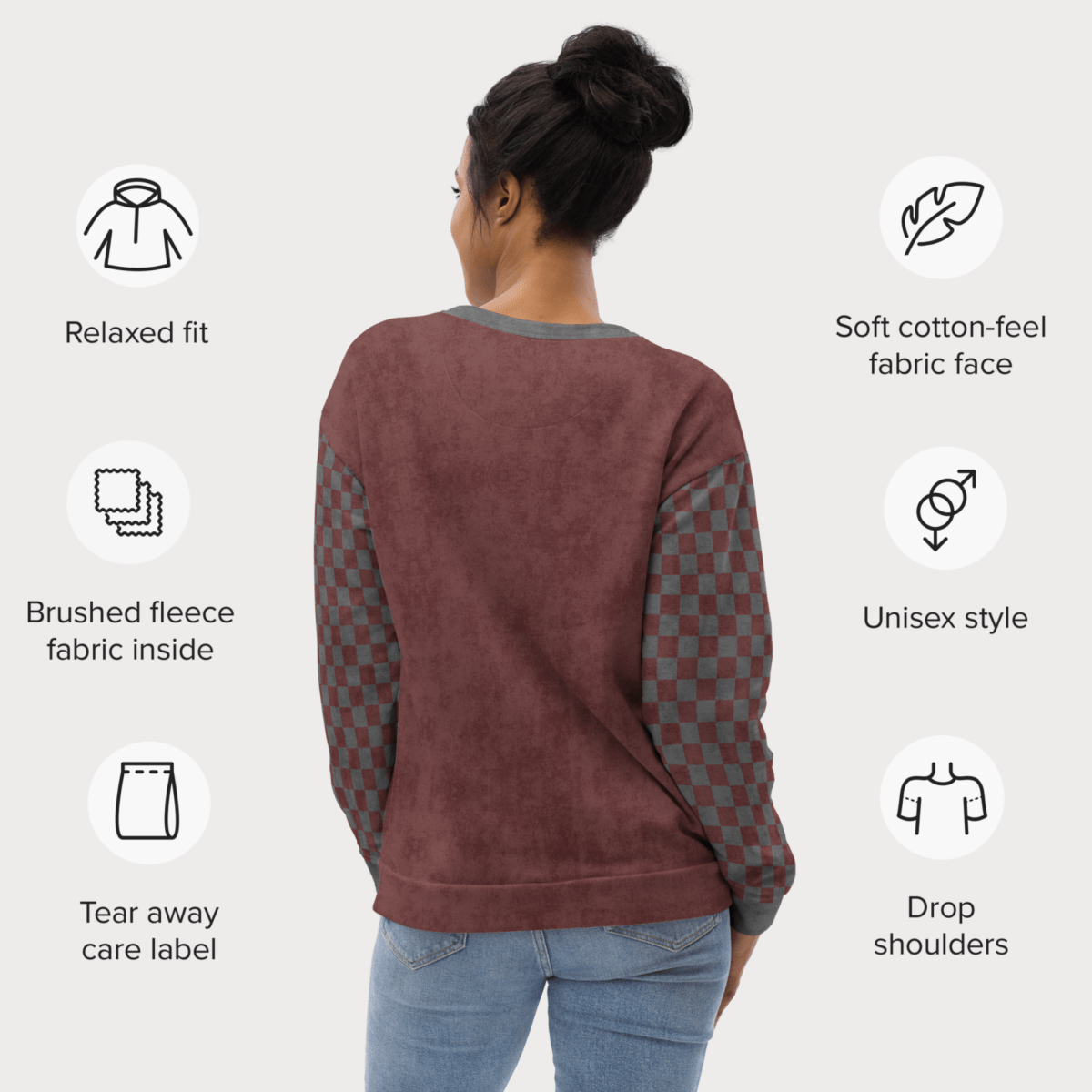 Person wearing a burgundy sweatshirt with text describing features on a white background