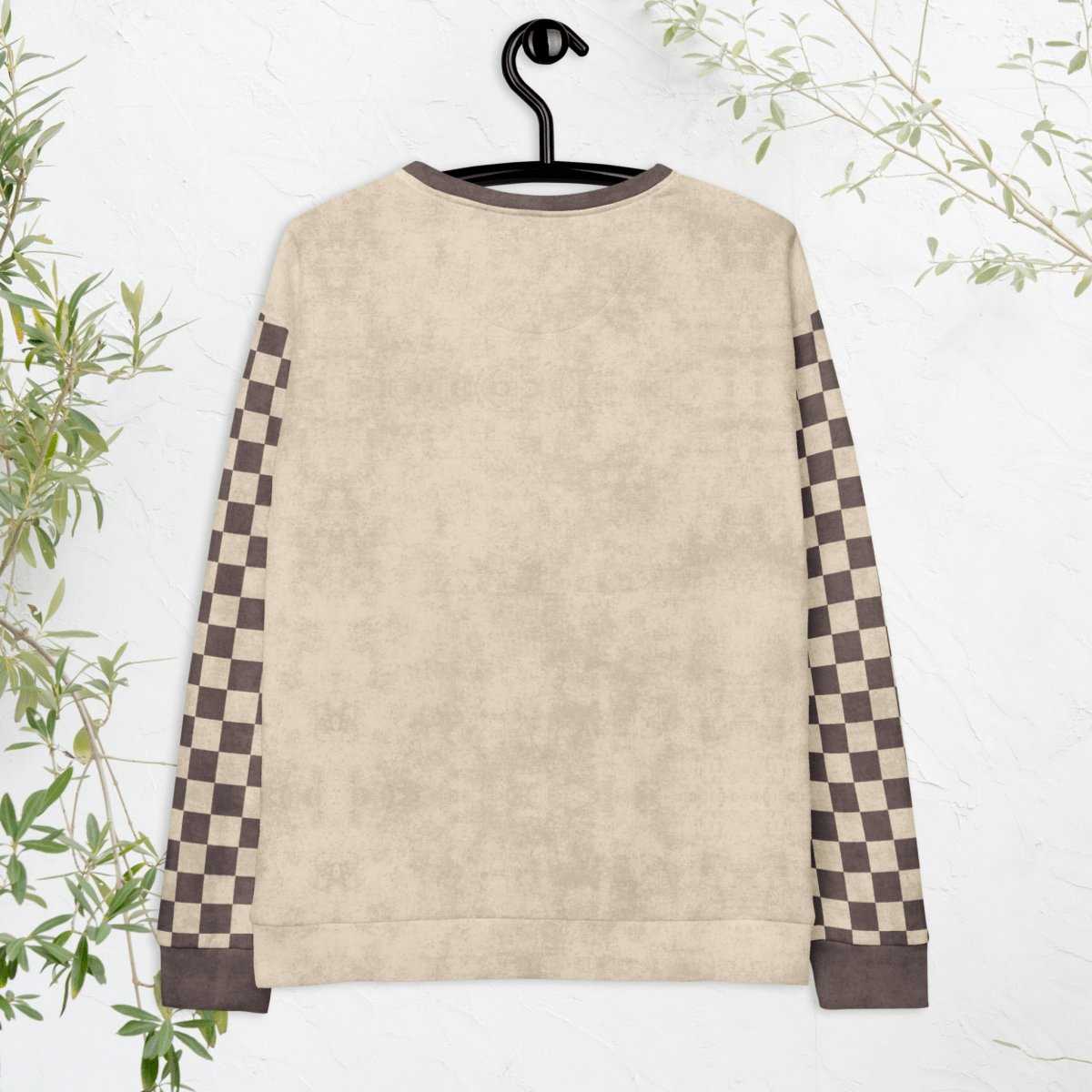 back view of hanging Beige crewneck sweatshirt with espresso checkered sleeves. Featuring a raccoon reading a book graphic and text 'Not my trash, not my dumpster'