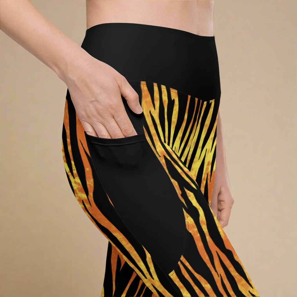 Black leggings with orange and yellow tiger stripe pattern on a beige background