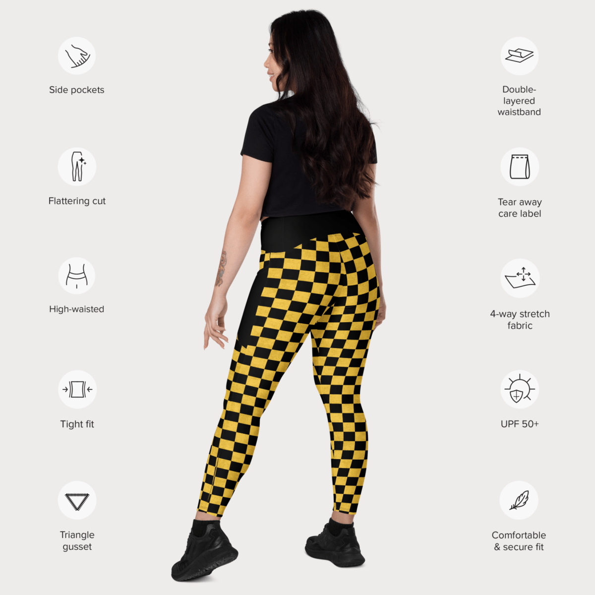 Woman wearing black and yellow checkered leggings with feature icons on a white background